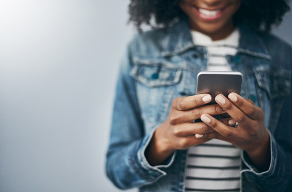 Woman looking at website on her phone in St. Louis, MO office.